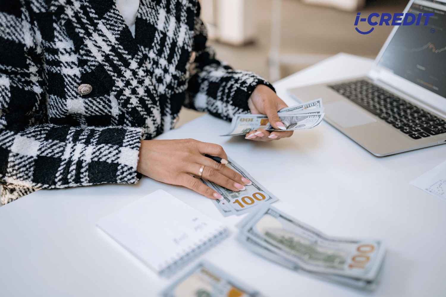 Woman counting cash at desk, what is a Licensed Moneylender In Singapore explained 