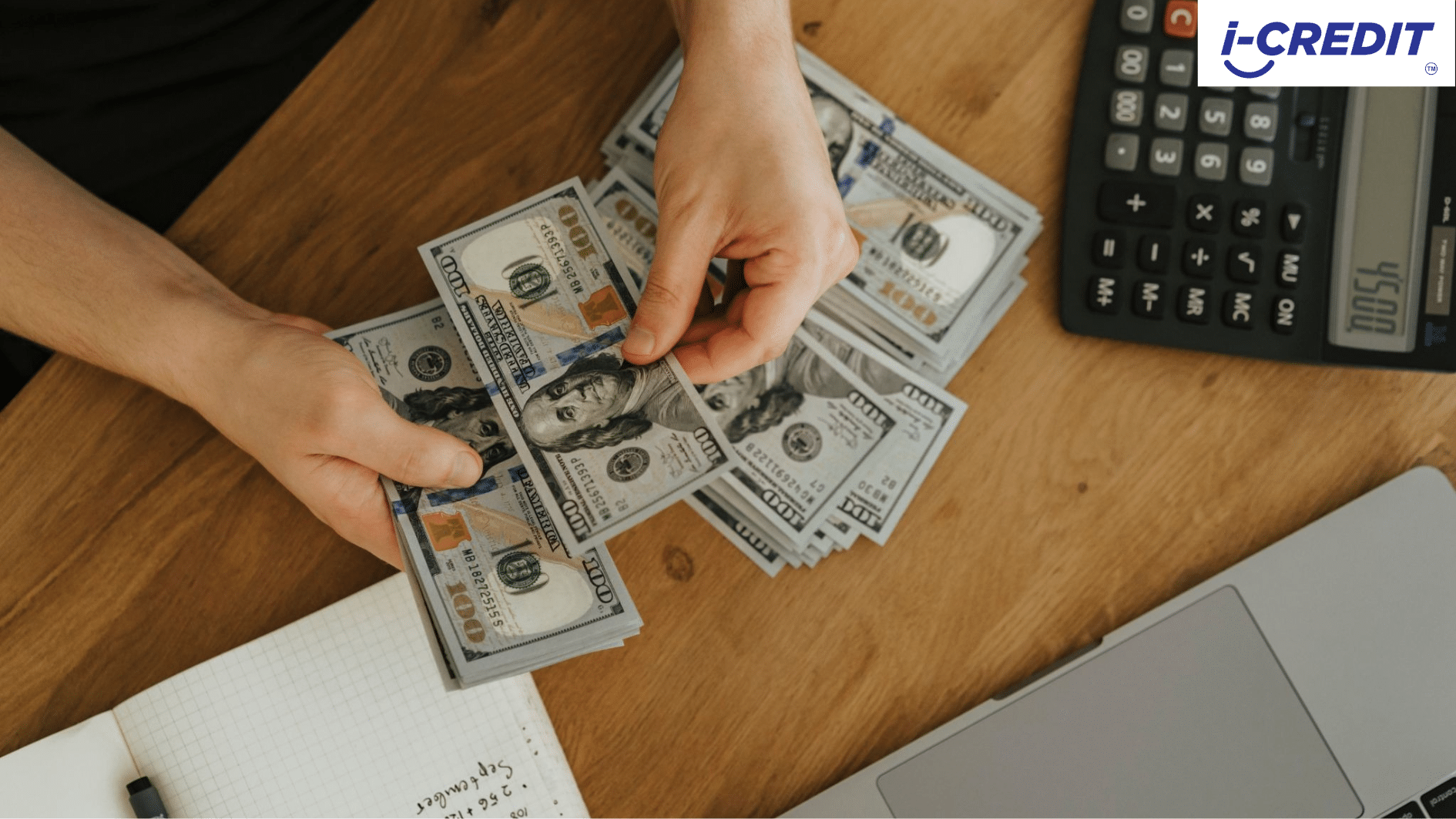 Hands counting cash beside a calculator and notebook, representing the cost decision in Licensed Moneylender vs Bank Personal Loan
